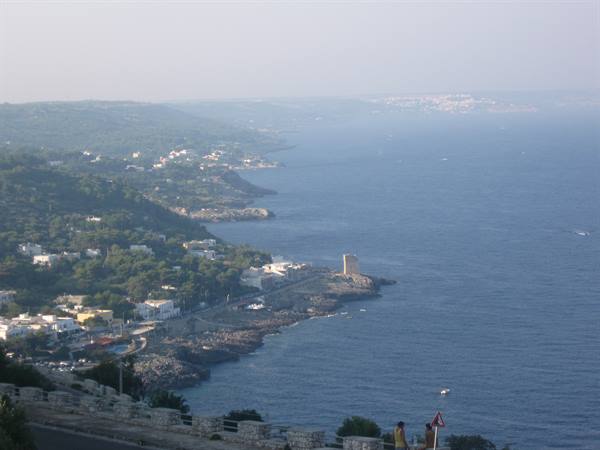 Rocky coastline with coastal tower and white houses by the sea