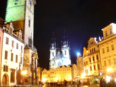 Prague Old Town Square at night, clock tower and lit Týn Church