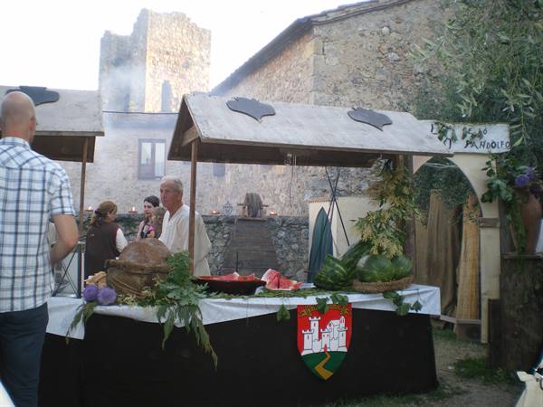 Stone market stall with melons and watermelons at Monteriggioni medieval festival