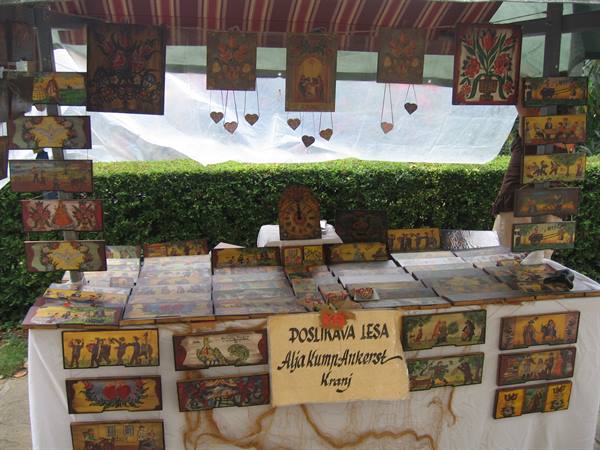 Plaques with typical Slovenian scenes, funny and not. Folk market in Ankaran