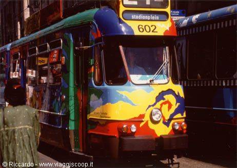 Colorfully painted tram number 602 heading to Stationplein, yellow and blue artwork