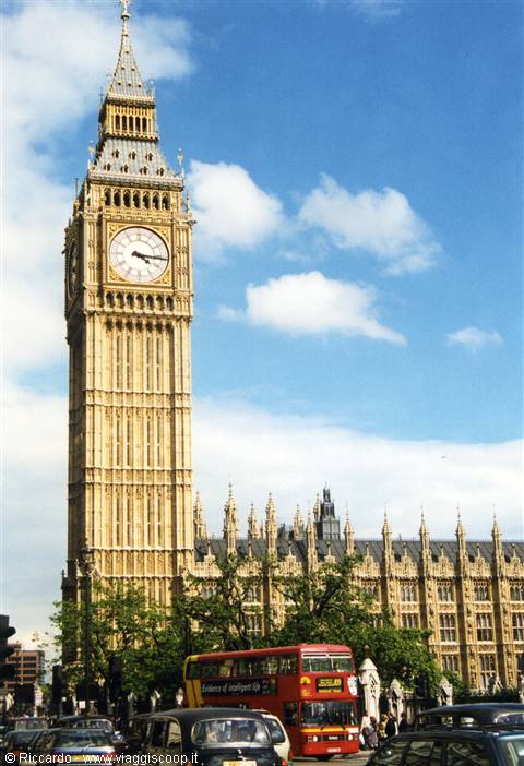 Big Ben in London with a red double-decker bus in traffic