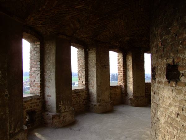 Brick chamber with large arched windows overlooking the countryside
