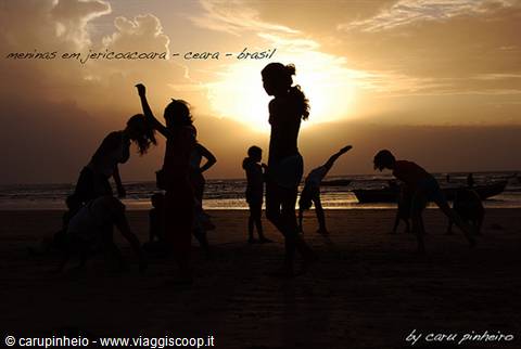 Children silhouetted playing on Jericoacoara beach at sunset