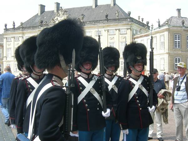 Danish royal guards in black bearskin caps in front of Amalienborg