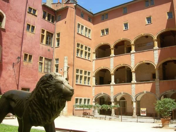 Bronze lion statue in the arcaded Renaissance courtyard of Vieux Lyon