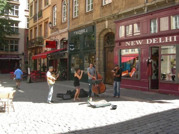 Strasbourg, street musicians playing guitar, violin and double bass on cobblestones
