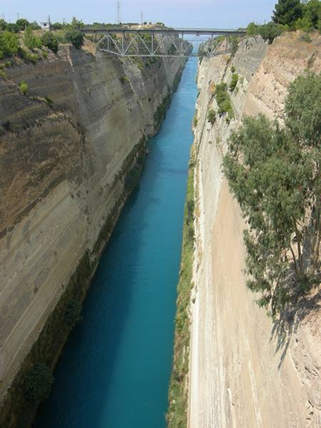 The Corinth Canal: turquoise water between steep rock walls, steel bridge above