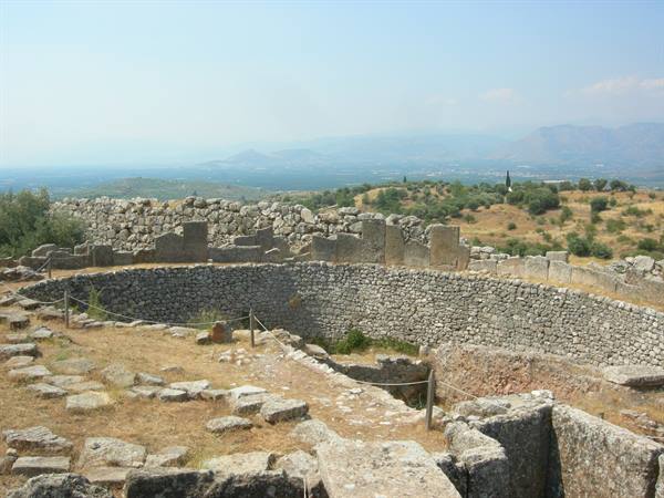 Stone grave circle at Mycenae, cyclopean walls and mountains beyond the plain