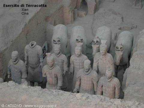 Terracotta warriors and horses in Xi'an excavation pit, soft light