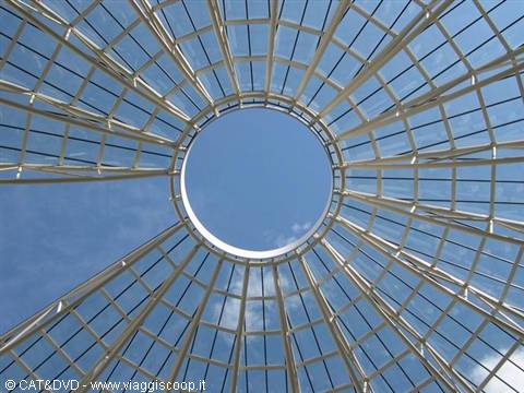 Glass and white steel dome with central oculus, blue sky below