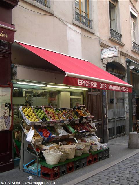 Grocery shop Épicerie des Marronniers, red awning, fruit crates on cobbled street