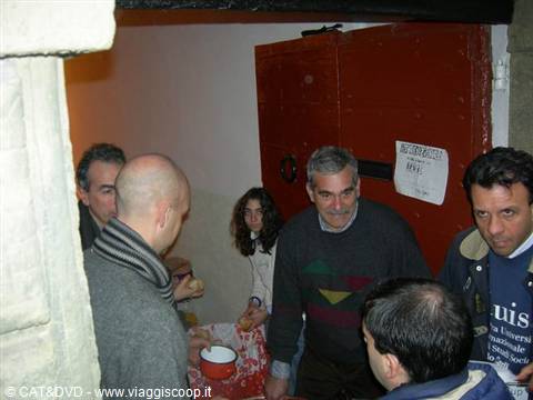 Group of people near a red door in a warm-lit indoor room