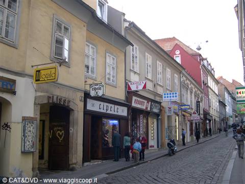 Radiceva street in Zagreb: colorful buildings, shops, cobbled pavement, pedestrians walking
