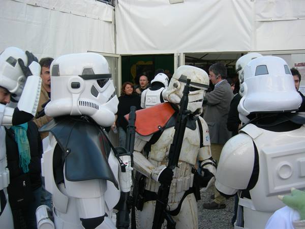 Cosplayers in stormtrooper armor gathered under a white tent