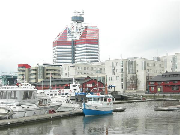 Boats moored at the harbor in front of the red Lilla Bommen tower, Gothenburg