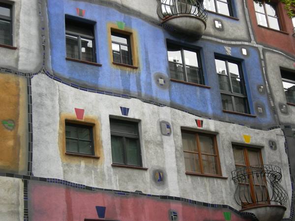 Colorful facade with irregular plaster and wrought-iron balconies, Hundertwasserhaus
