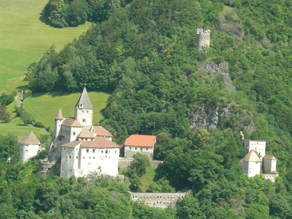 Trostburg Castle, white walls and red roofs among green woods and meadows