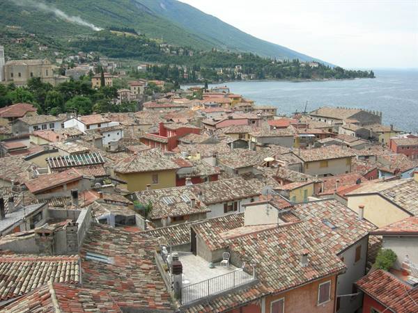 Terracotta rooftops of Malcesine overlooking Lake Garda beneath green mountains