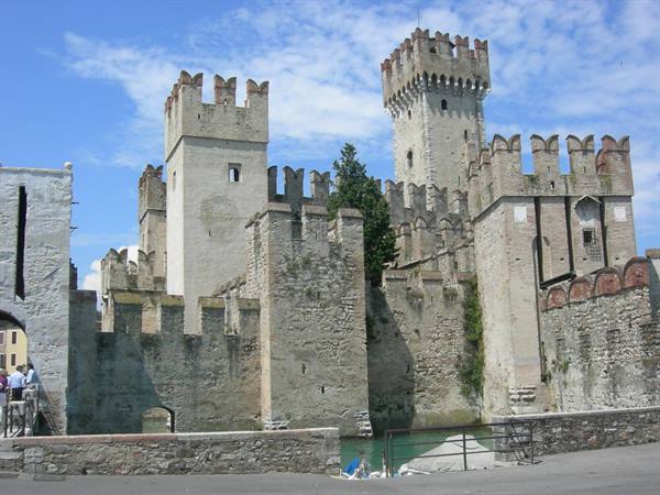 Scaligero Castle in Sirmione, stone battlements, towers and turquoise water