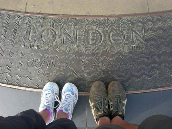 Two pairs of shoes on a bronze plaque reading London River Thames