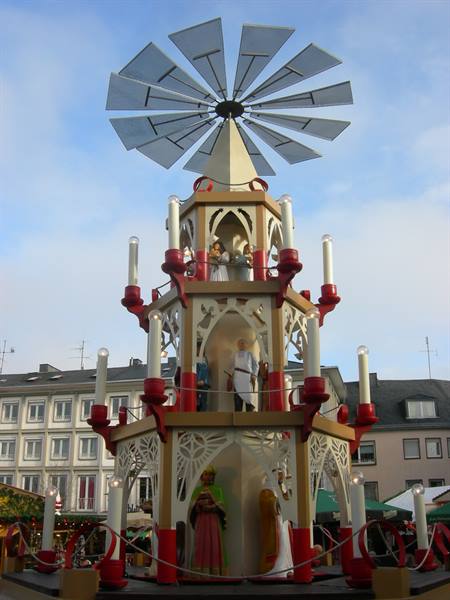 Wooden Christmas pyramid with red candles and angels in a German square