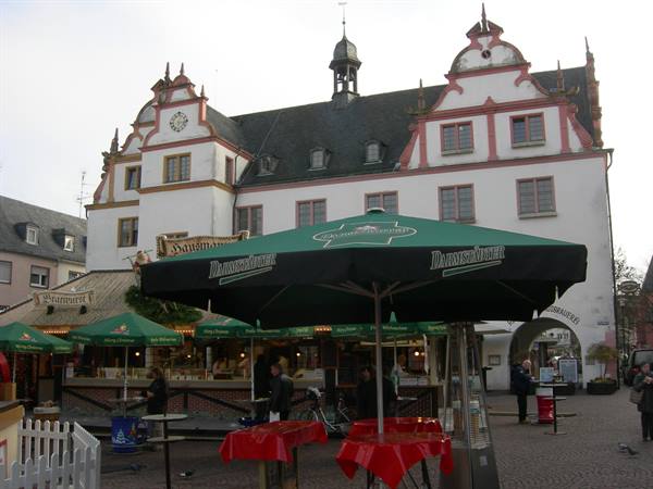 Green beer umbrellas in front of Darmstadt's old Renaissance town hall
