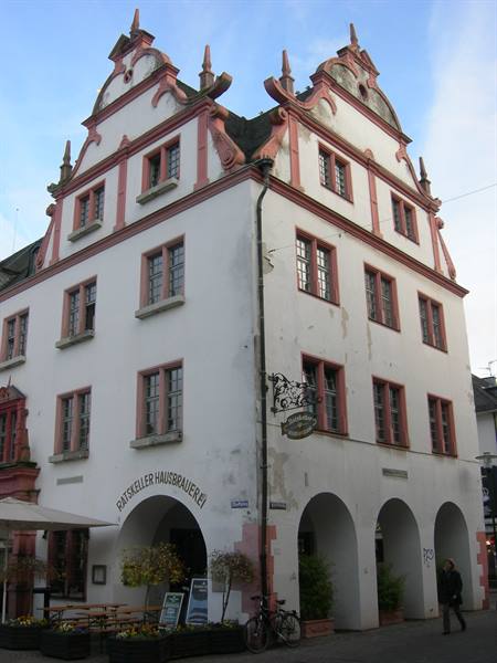 Historic building with pink gables and brewery sign above arched arcades
