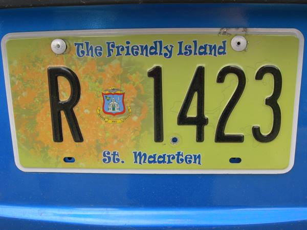 Yellow St. Maarten license plate R1423 on blue car body