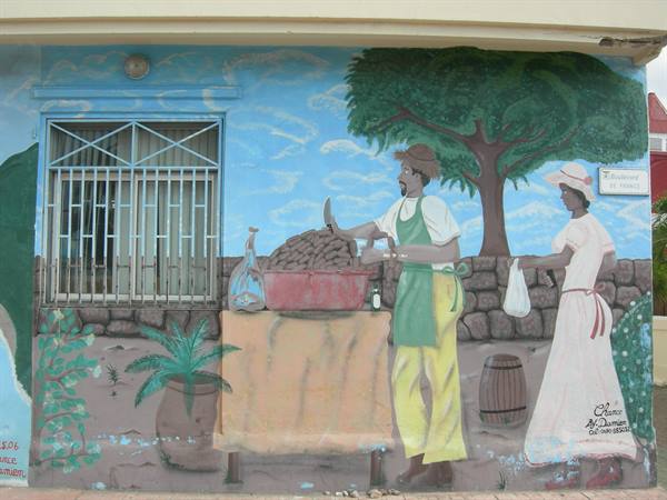 Colorful mural on wall: man sells fruits in red bowl, woman buying under a tree