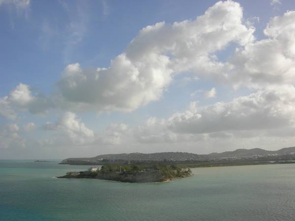 Antigua: rocky headland with Fort James, turquoise water, white clouds