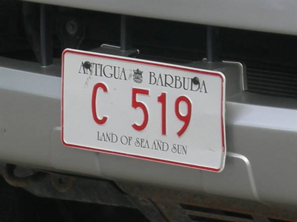 White Antigua and Barbuda license plate C 519 on gray bumper