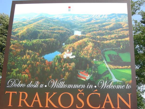 Welcome sign of Trakošćan with aerial photo of the castle among autumn woods