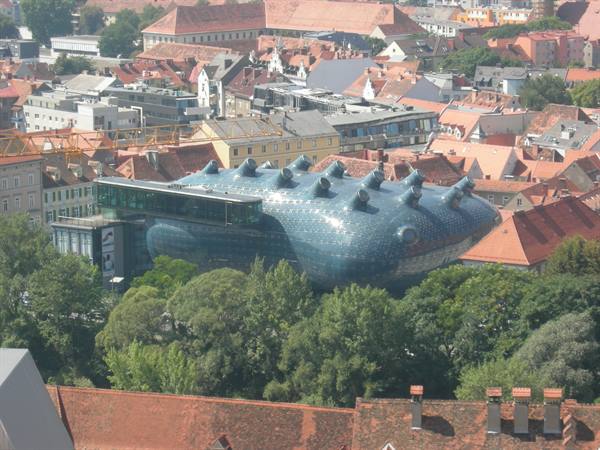 The Kunsthaus in Graz, blue bubble museum among red rooftops and trees