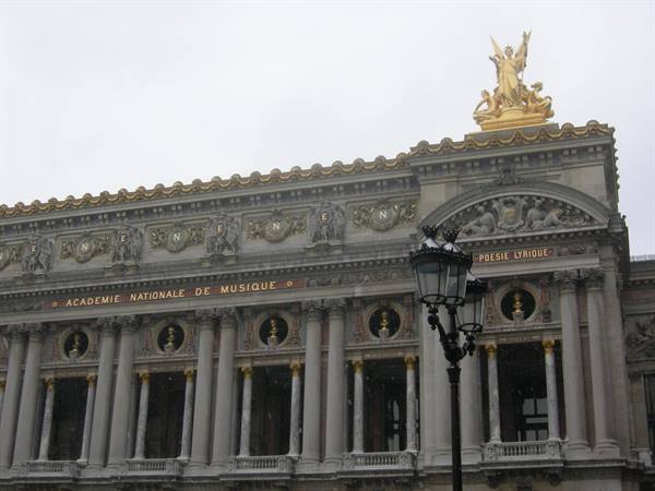 Facade of the Opéra Garnier in Paris with golden statues and black lampposts