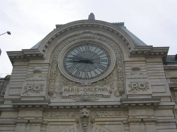 Large stone clock on the facade of the Musée d'Orsay in Paris