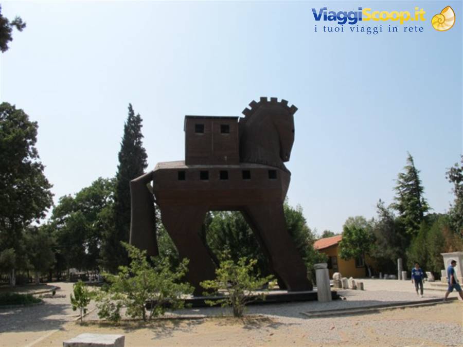 Wooden Trojan Horse, tourists walk through the sunny archaeological site