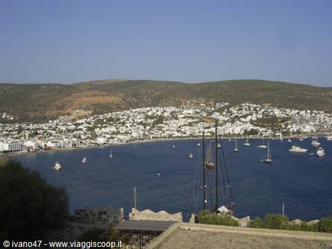 Bodrum bay with anchored yachts and white houses over the hills