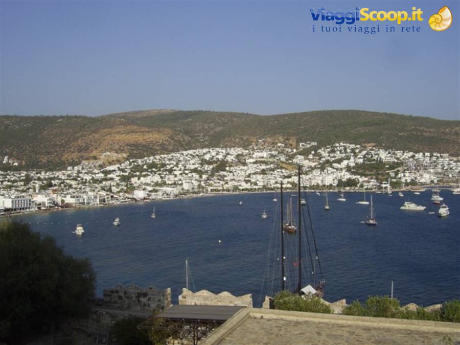 Bodrum bay with anchored yachts and white houses over the hills