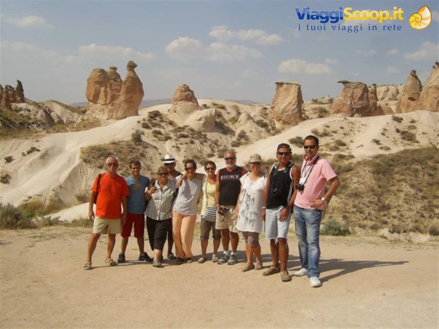 Group of tourists posing among fairy chimneys in Cappadocia