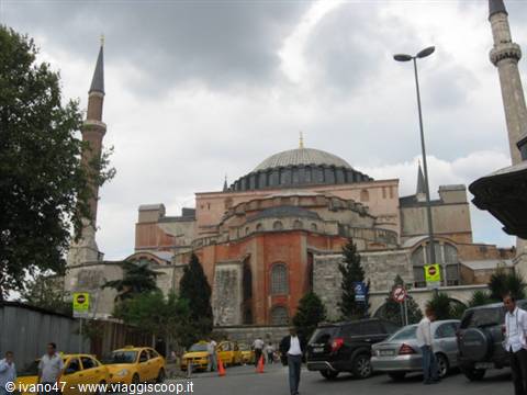 Hagia Sophia in Istanbul: dome and minarets among yellow taxis and clouds