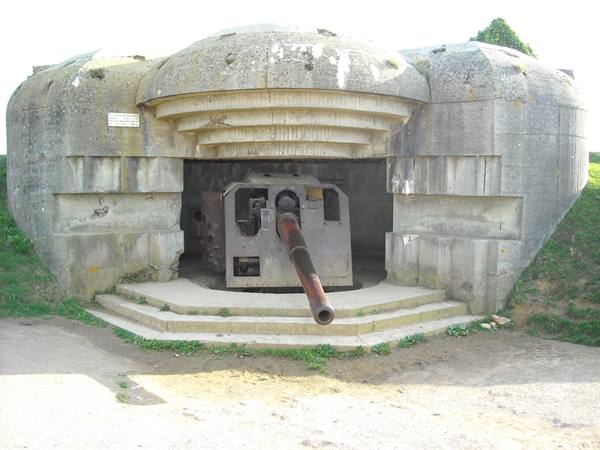 one of the four German defence cannons and below we see them from afar