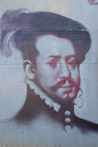 Mural on concrete wall: portrait of a nobleman with ruffled collar and plume