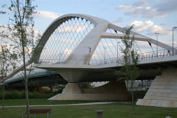 Third Millennium Bridge in Zaragoza, white concrete arch among trees