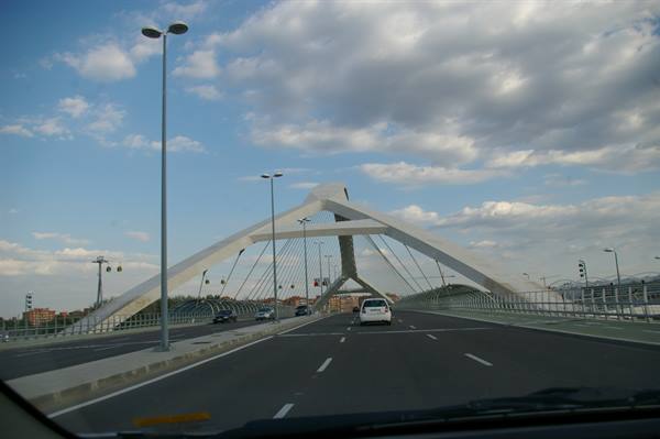 Alamillo Bridge in Seville, white leaning pylon with cables, cars driving across