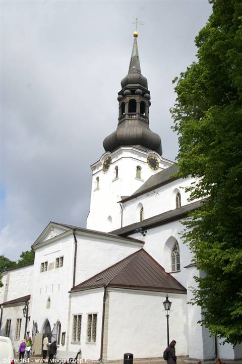 White Lutheran cathedral in Tallinn's Toompea, baroque bell tower under cloudy sky