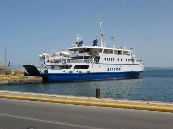 White and blue Saremar ferry moored at the harbor pier under clear sky