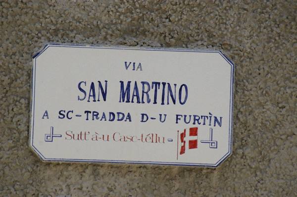 White and blue ceramic street sign for Via San Martino