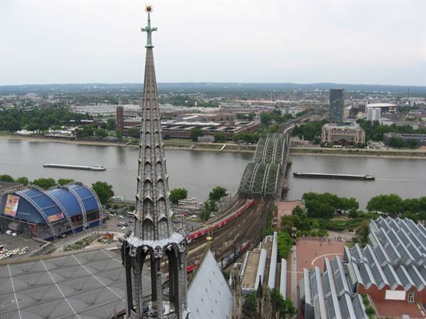 Cologne Cathedral spire above the Rhine river and Hohenzollern bridge