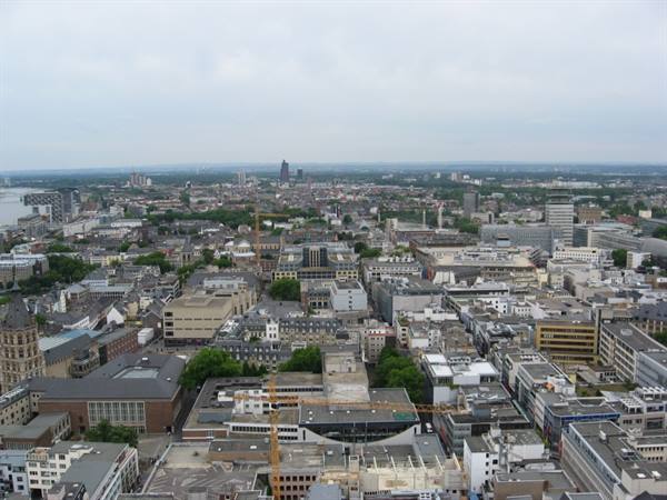 Cologne rooftops and skyscrapers under a grey sky, from the cathedral